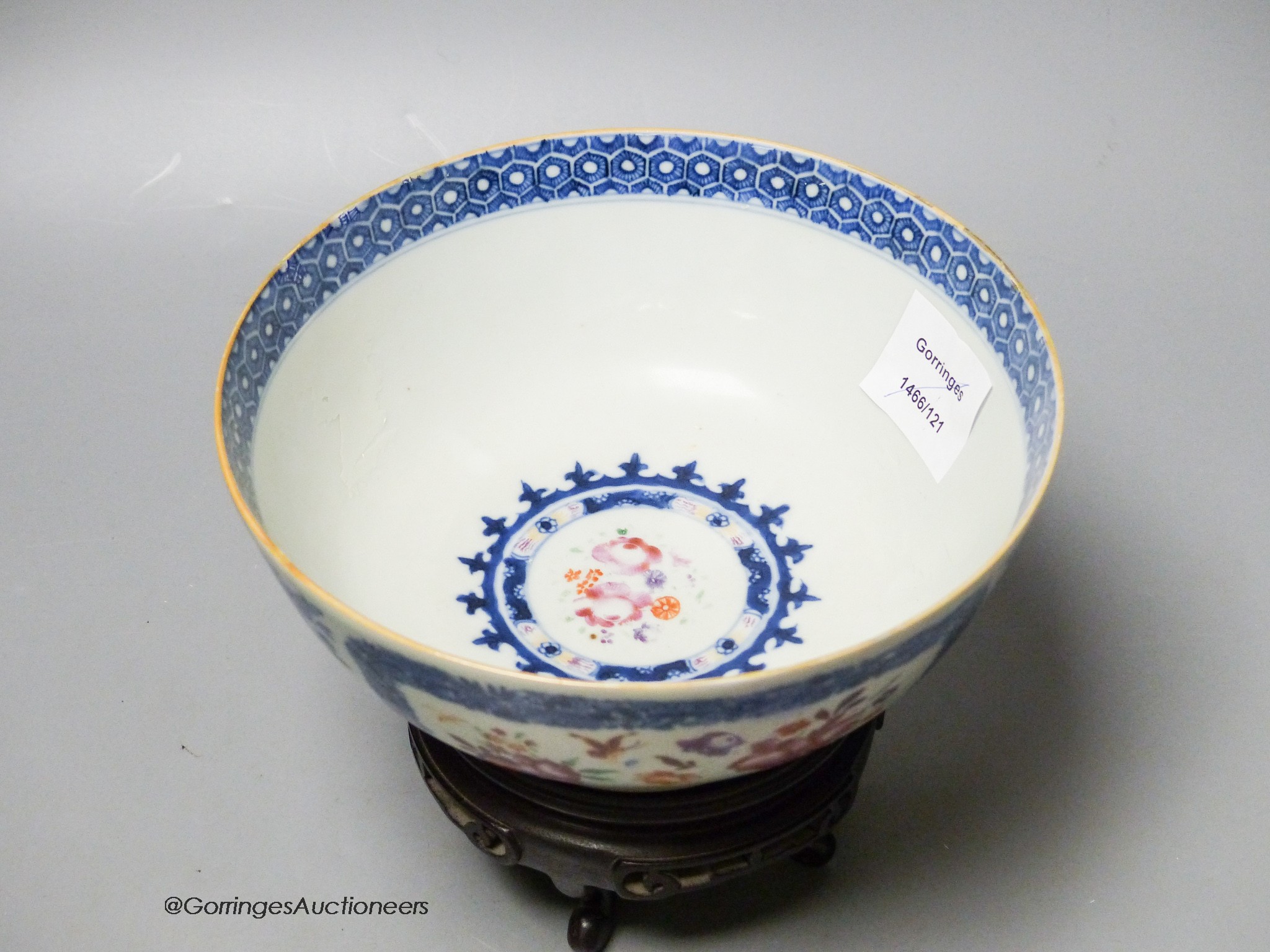 A 18th century Chinese export porcelain footed punch bowl on hardwood stand, diameter 20cm, restored